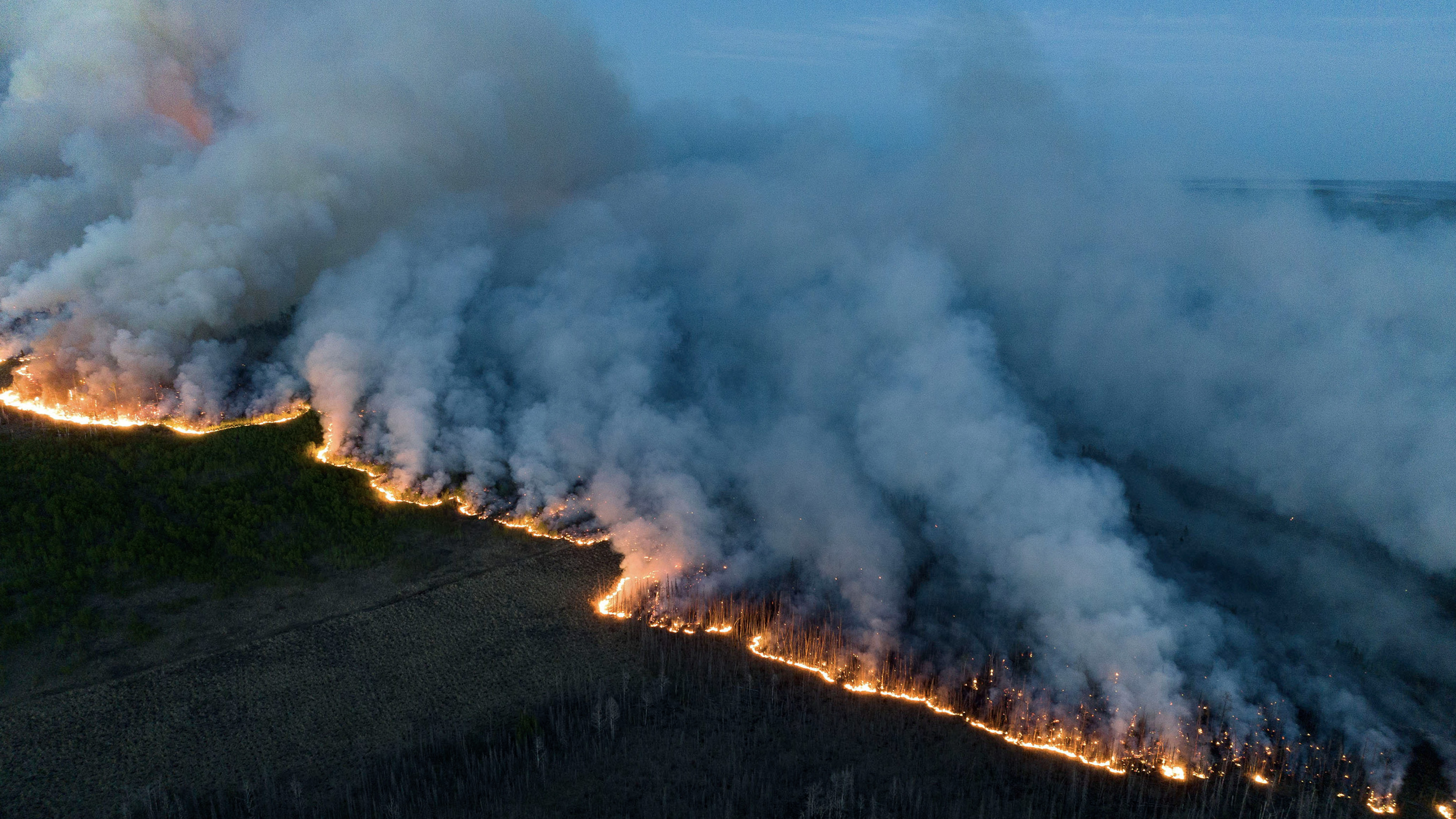 Wildfire on a ridgeline at dusk